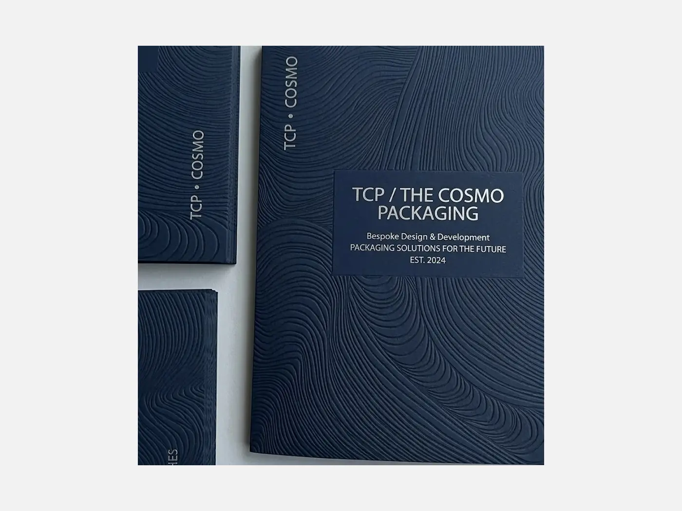 Textured stock packaging material with a tactile specialty paper surface